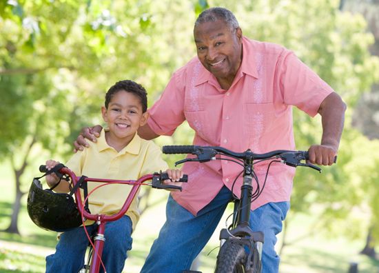 Older Man and Young Girl Having Fun Riding Bikes
